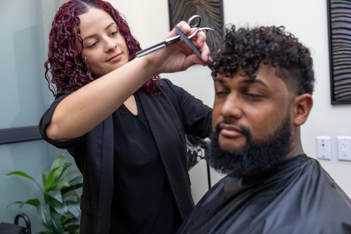 Hilary cutting a client's hair at Three One Seven Hair Studio in Sanford