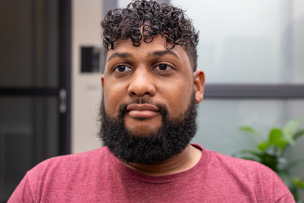 Front view of a finished men's curly cut and taper fade by Hilary at Three One Seven Hair Studio, Sanford