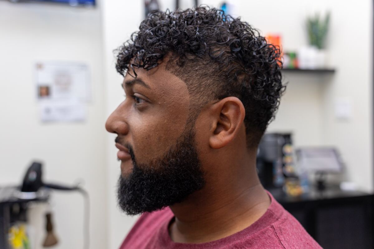 Profile of the same finished curly cut, showing the blend through the temple