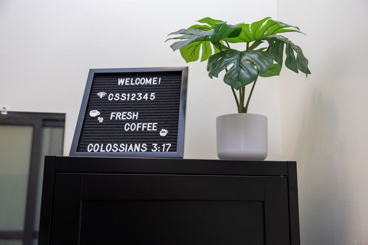 Welcome board at Three One Seven Hair Studio listing guest WiFi and fresh coffee